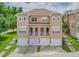 An aerial view of tan townhouses each featuring a garage and well manicured landscaping at 94 S Highland Ave # 2402, Tarpon Springs, FL 34689