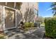 Townhouse entrance featuring a landscaped walkway and an HVAC unit at 94 S Highland Ave # 2402, Tarpon Springs, FL 34689