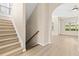 Bright foyer featuring a staircase and access to the open-concept living spaces at 94 S Highland Ave # 2402, Tarpon Springs, FL 34689
