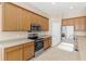 Kitchen featuring modern stainless steel appliances, light wood cabinets, and spacious countertops at 94 S Highland Ave # 2402, Tarpon Springs, FL 34689