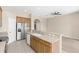 Kitchen with stainless steel appliances, light wood cabinets, and an eat-in breakfast bar at 94 S Highland Ave # 2402, Tarpon Springs, FL 34689
