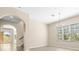 Open-concept living room featuring an archway, stairs, and outdoor patio entrance at 94 S Highland Ave # 2402, Tarpon Springs, FL 34689