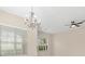 Bright living room with neutral walls, large windows, chandelier, and ceiling fan at 94 S Highland Ave # 2402, Tarpon Springs, FL 34689