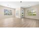 Bright and airy living room with modern hardwood floors and lots of windows at 94 S Highland Ave # 2402, Tarpon Springs, FL 34689