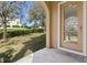 Tile patio featuring a view of the backyard landscaping and a glimpse of neighboring houses at 94 S Highland Ave # 2402, Tarpon Springs, FL 34689
