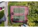 Overhead view of two tennis courts surrounded by lush greenery at 94 S Highland Ave # 2402, Tarpon Springs, FL 34689