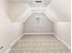 Finished attic space with neutral carpet and walls, and a window providing natural light at 0 Old Country Rd, Odessa, FL 33556