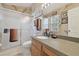 Bathroom with a walk-in shower featuring glass doors, a wood vanity, and a gray countertop at 11240 Windsor Place Circle Cir, Tampa, FL 33626