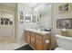 Bright bathroom features a modern vanity with a neutral countertop, mirrored wall, and ample lighting at 11240 Windsor Place Circle Cir, Tampa, FL 33626