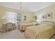 Bright bedroom with two twin beds, a window with white curtains, and neutral carpet at 11240 Windsor Place Circle Cir, Tampa, FL 33626