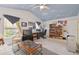 Bedroom with cloud painted ceiling offers a versatile space as an office, complete with seating and entertainment setup at 11240 Windsor Place Circle Cir, Tampa, FL 33626