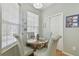 A cozy breakfast nook features a round table and chairs under bright windows at 11240 Windsor Place Circle Cir, Tampa, FL 33626