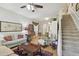Inviting living area featuring a comfortable seating arrangement and access to the staircase at 11240 Windsor Place Circle Cir, Tampa, FL 33626