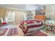 Bright main bedroom featuring a large window, a ceiling fan, and neutral colored carpet at 11240 Windsor Place Circle Cir, Tampa, FL 33626