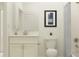 Bright bathroom with a single sink vanity, framed art, and shower with tub at 11853 Sparkling Topaz Cv, Parrish, FL 34219