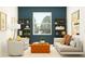 Stylish sitting area with an orange ottoman, comfortable chairs, and natural light at 11853 Sparkling Topaz Cv, Parrish, FL 34219