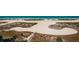 Breathtaking aerial view of a white sand beach along the coast with green vegetation at 1270 Gulf Blvd # 506, Clearwater Beach, FL 33767