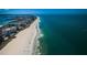Stunning aerial view showcasing a pristine white sand beach next to luxury high-rise condo buildings at 1270 Gulf Blvd # 506, Clearwater Beach, FL 33767