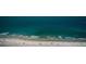 Stunning aerial view of a white sand beach along the coast with blue-green ocean water at 1270 Gulf Blvd # 506, Clearwater Beach, FL 33767