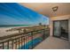 Expansive balcony overlooking a sparkling pool, the beach, and the Gulf, offering a resort-like experience at 1270 Gulf Blvd # 506, Clearwater Beach, FL 33767