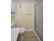 Neutral bathroom features a toilet, a shower with glass doors, and white cabinets at 1270 Gulf Blvd # 506, Clearwater Beach, FL 33767