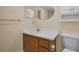 Neutral bathroom features a wood vanity, a white sink and a toilet at 1270 Gulf Blvd # 506, Clearwater Beach, FL 33767