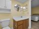 Cozy bathroom with toilet, vanity, sink, medicine cabinet, and wood-look floor at 1270 Gulf Blvd # 506, Clearwater Beach, FL 33767