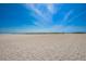 Expansive view of a pristine sandy beach under a clear, blue sky at 1270 Gulf Blvd # 506, Clearwater Beach, FL 33767