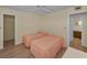 Bright bedroom features two twin beds, ceiling fan, and an ensuite bathroom at 1270 Gulf Blvd # 506, Clearwater Beach, FL 33767