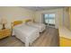Bright bedroom with two beds and sliding door to balcony showcasing beautiful water views at 1270 Gulf Blvd # 506, Clearwater Beach, FL 33767