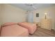 Bright bedroom features two twin beds, a dresser, and vinyl flooring at 1270 Gulf Blvd # 506, Clearwater Beach, FL 33767