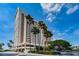 Elegant condo building showcasing coastal living with palm trees against a clear blue sky at 1270 Gulf Blvd # 506, Clearwater Beach, FL 33767