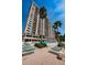 Luxury condo exterior with a clear blue pool and plenty of lounge chairs to relax on at 1270 Gulf Blvd # 506, Clearwater Beach, FL 33767