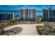 Stunning high-rise condominium exterior view with tropical landscaping at 1270 Gulf Blvd # 506, Clearwater Beach, FL 33767