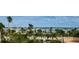 Condo community view showcasing palm trees, waterfront access, and clear blue skies at 1270 Gulf Blvd # 506, Clearwater Beach, FL 33767