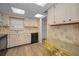 Functional kitchen featuring ample cabinetry, a sink, and views to the dining area at 1270 Gulf Blvd # 506, Clearwater Beach, FL 33767