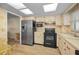 Well-lit kitchen with stainless steel refrigerator and functional layout, perfect for everyday cooking at 1270 Gulf Blvd # 506, Clearwater Beach, FL 33767