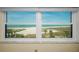 Breathtaking ocean views from the condo's large window, displaying the beach and sky at 1270 Gulf Blvd # 506, Clearwater Beach, FL 33767