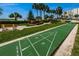 A shuffleboard court surrounded by green grass and landscaping at 1270 Gulf Blvd # 506, Clearwater Beach, FL 33767