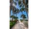Picturesque paver walkway through lush landscaping leading to the beach at 1270 Gulf Blvd # 506, Clearwater Beach, FL 33767