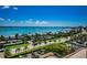 Beautiful water view from a high-rise condo with lush landscaping and palm trees at 1270 Gulf Blvd # 506, Clearwater Beach, FL 33767