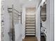 Well-organized laundry room featuring patterned wallpaper, floating shelves, and modern appliances at 132 Mirror Lake N Dr # 401, St Petersburg, FL 33701