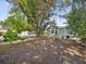 Cozy backyard featuring a small patio set under the shade of mature trees, perfect for outdoor relaxation at 1679 29Th N Ave, St Petersburg, FL 33713