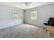 Neutral bedroom featuring carpet flooring, two windows, and a ceiling fan at 1679 29Th N Ave, St Petersburg, FL 33713