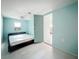 Serene bedroom with light blue walls, a ceiling fan, and sliding glass doors for easy access at 1679 29Th N Ave, St Petersburg, FL 33713