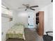 Simple bedroom with a ceiling fan, window A/C, and a view of the adjoining bathroom at 1679 29Th N Ave, St Petersburg, FL 33713