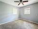 Neutral bedroom featuring carpet flooring, a ceiling fan, and a bright window at 1679 29Th N Ave, St Petersburg, FL 33713