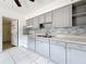 Modern kitchen featuring gray cabinets, a double sink, and light-colored countertops at 1679 29Th N Ave, St Petersburg, FL 33713