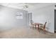 Cozy living room featuring neutral carpet, ceiling fan and a table set by a window at 1679 29Th N Ave, St Petersburg, FL 33713