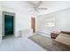 Bright living room featuring a ceiling fan, neutral-toned furniture, and ample natural light from the window at 1679 29Th N Ave, St Petersburg, FL 33713